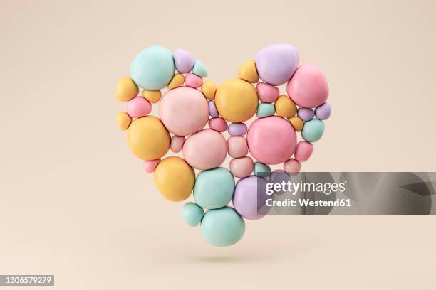 three dimensional render of floating heart made of pastel colored spheres - heart shape 3d stock pictures, royalty-free photos & images