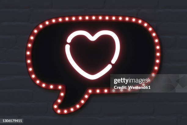 illuminated speech bubble with heart shape on black brick wall - neon speech bubble stock-fotos und bilder
