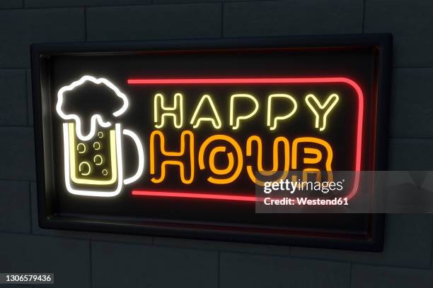 illuminated beer glass with happy hour text on black wall - happy hour fotografías e imágenes de stock