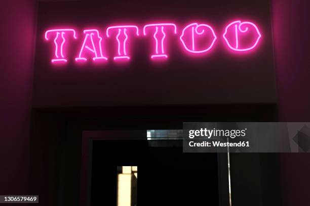 illuminated tattoo text on door - alphabet neon stock pictures, royalty-free photos & images