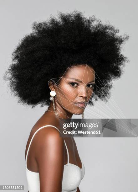 afro woman with facial recognition laser beams against white background - artificial intelligence white background stock-fotos und bilder