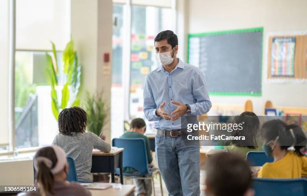 masked school teacher stock photo - classroom masks stock pictures, royalty-free photos & images