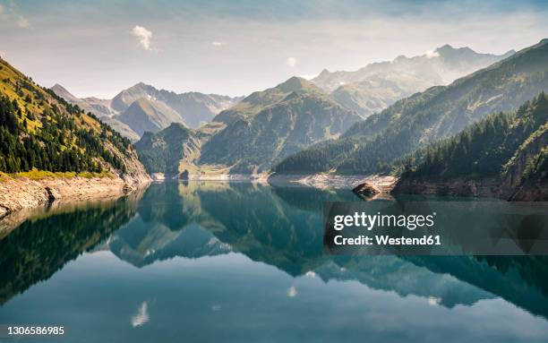 awe view of luzzone lake with adula alps in background at ticino, switzerland - tessin stock-fotos und bilder