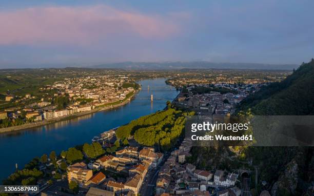 france, tournon sur rhone, townscape with river at sunset - rhone river stock pictures, royalty-free photos & images