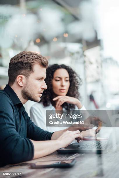 Two People Facing Each Other On Computers Photos and Premium High Res ...