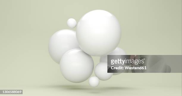 three dimensional render of white bubbles floating against green background - ball stock illustrations