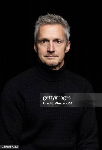 serious mature man against black background - portrait on black background stock pictures, royalty-free photos & images