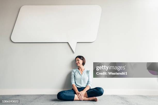 thoughtful female professional sitting in office against wall - sitting on ground stock pictures, royalty-free photos & images