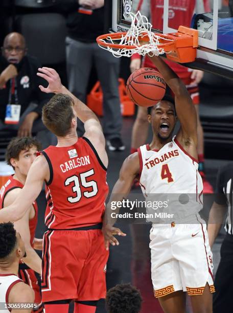 Evan Mobley of the USC Trojans dunks against Branden Carlson of the Utah Utes during the quarterfinals of the Pac-12 Conference basketball tournament...