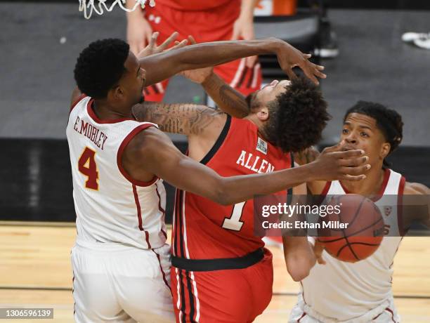 Evan Mobley of the USC Trojans fouls Timmy Allen of the Utah Utes during the quarterfinals of the Pac-12 Conference basketball tournament at T-Mobile...