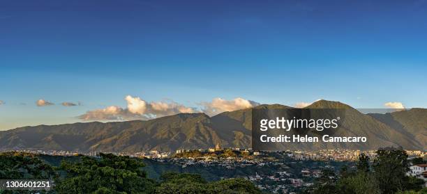 panoramic view of caracas city at sunset with el avila at the background - caracas stock pictures, royalty-free photos & images