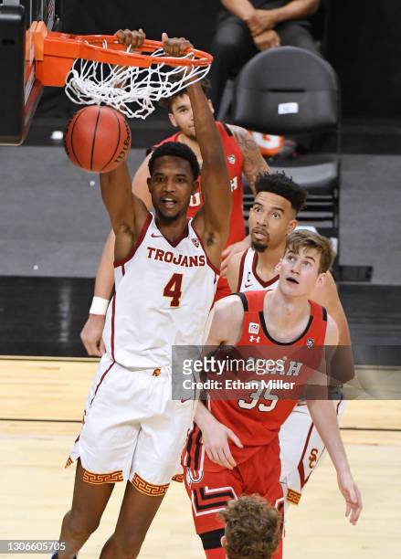 Evan Mobley of the USC Trojans dunks ahead of Branden Carlson of the Utah Utes during the quarterfinals of the Pac-12 Conference basketball...