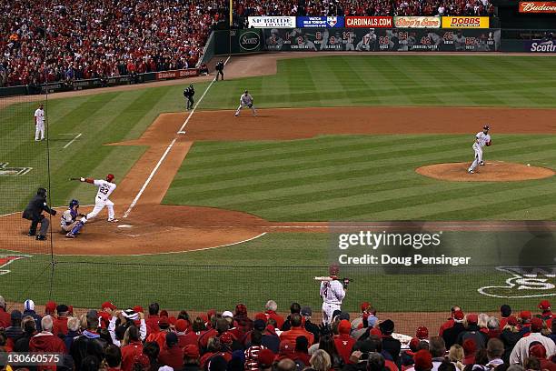 David Freese of the St. Louis Cardinals hits a two-run RBI triple to tie the game in the bottom of the ninth during Game Six of the MLB World Series...