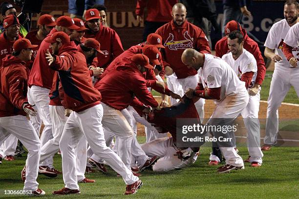 The St. Louis Cardinals bench rip the jersey shirt off of David Freese after hitting a walk off solo home run in the 11th inning to win Game Six of...