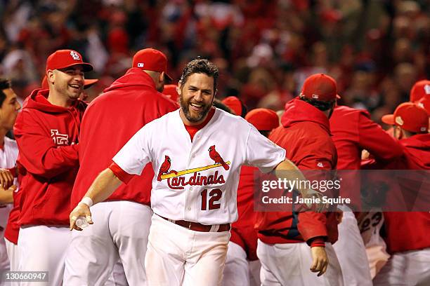 Lance Berkman of the St. Louis Cardinals celebrates after David Freese hits a walk off solo home run in the 11th inning to win Game Six of the MLB...