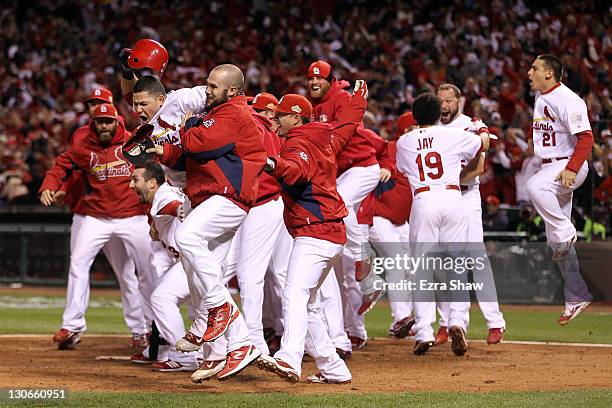 Yadier Molina of the St. Louis Cardinals celebrates after David Freese hits a walk off solo home run in the 11th inning to win Game Six of the MLB...