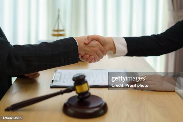 good service cooperation of consultation between a male lawyer and business woman customer, handshake after good deal agreement, law and legal concept. - service agreement stock pictures, royalty-free photos & images