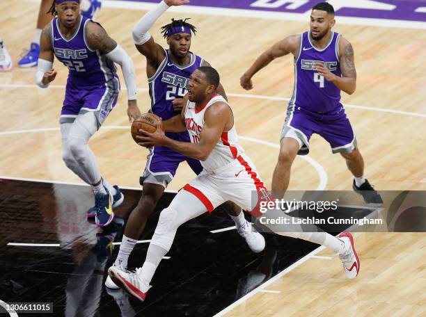 Eric Gordon of the Houston Rockets drives to the basket against Richaun Holmes, Buddy Hield and Cory Joseph of the Sacramento Kings in the first half...