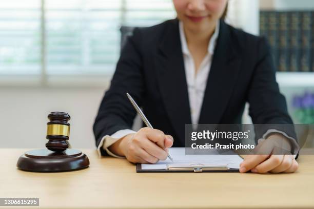 lawyer businesswoman working and notary signs the documents at office. consultant lawyer, justice and law ,attorney, court judge, concept. - notar stock-fotos und bilder
