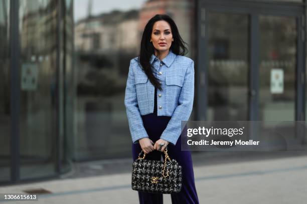 Yvonne Mhoulen wearing Zara jacket, Norma Kamali purple jumpsuit and Chanel bag on February 27, 2021 in Dusseldorf, Germany.