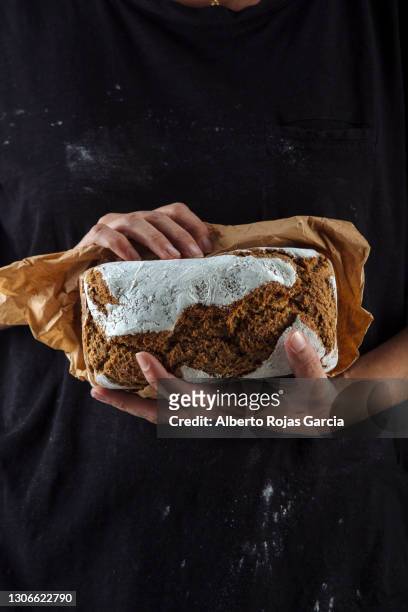 artisan baker with a piece of bread - man offering bread stock pictures, royalty-free photos & images