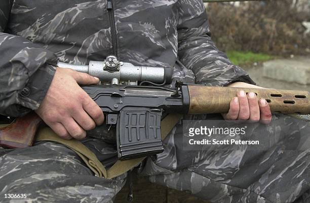 Russian soldier cradles his gun November 23, 2000 while on patrol in Grozny, capital of the breakaway republic of Chechnya. Russian forces have been...