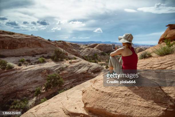 adventures in desert of usa southwest: woman hiking near canyonlands, moab - hiking utah stock pictures, royalty-free photos & images