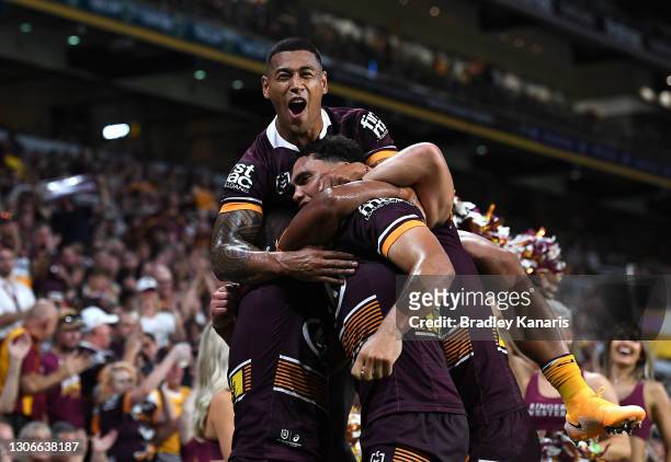 Xavier Coates of the Broncos celebrates with Jamayne Isaako of the Broncos after scoring a try during the round one NRL match between the Brisbane...