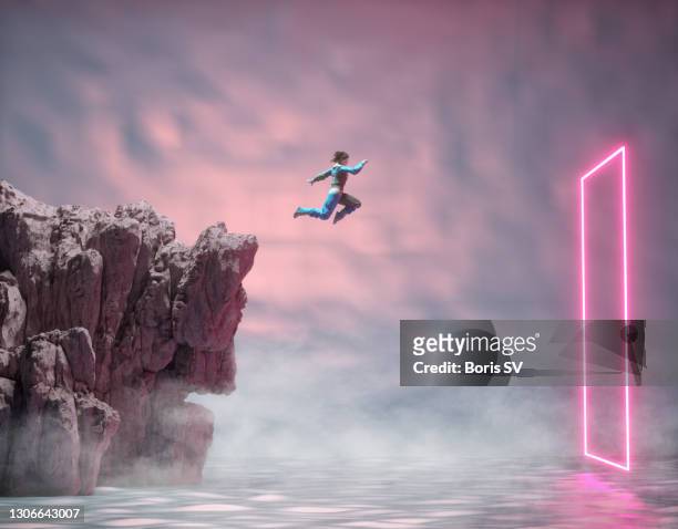woman jumping into a rectangular portal - anticipation photos et images de collection