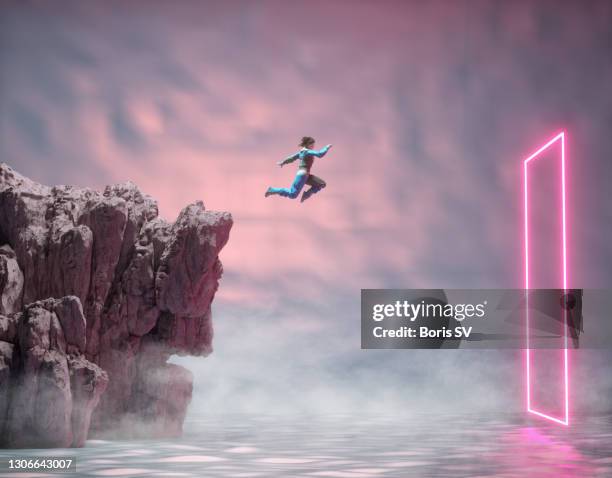 woman jumping into a rectangular portal - people jumping stockfoto's en -beelden