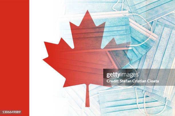 canadian flag over face protective masks - canada covid stock pictures, royalty-free photos & images