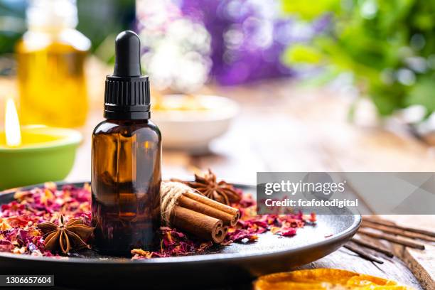 aromatherapy: essential oil bottle on wooden table. copy space - cinnamon stock pictures, royalty-free photos & images