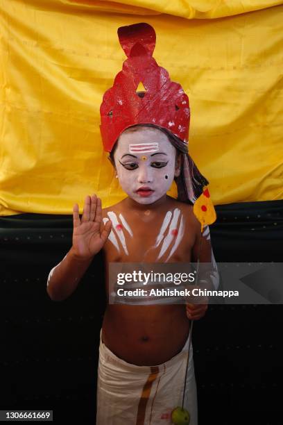 Young boy with his body painted in the likeness of a Hindu god poses for a photo during Maha Shivaratri celebrations on March 12, 2021 in...