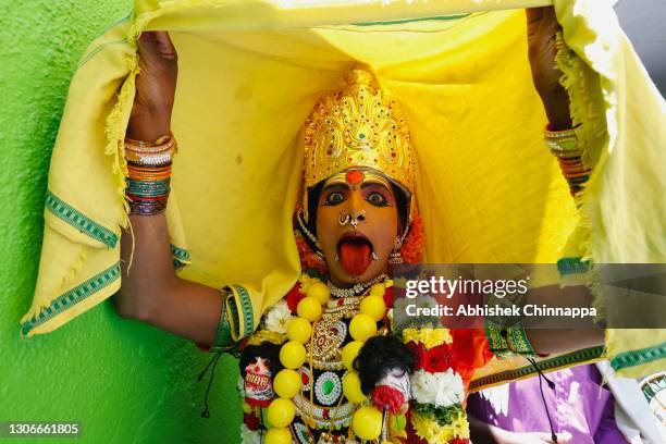 Man dressed in the style of a Hindu goddess dances in a trance as he celebrates Maha Shivaratri on March 12, 2021 in Kaveripattinam, India. Maha...