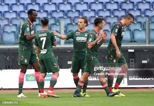 Simy Nwankwo of Crotone celebrates with Adam Ounas and team mates after scoring their side's first goal during the Serie A match between SS Lazio and...