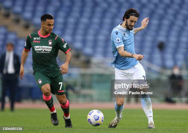 Luis Alberto of S.S. Lazio is challenged by Adam Ounas of Crotone during the Serie A match between SS Lazio and FC Crotone at Stadio Olimpico on...