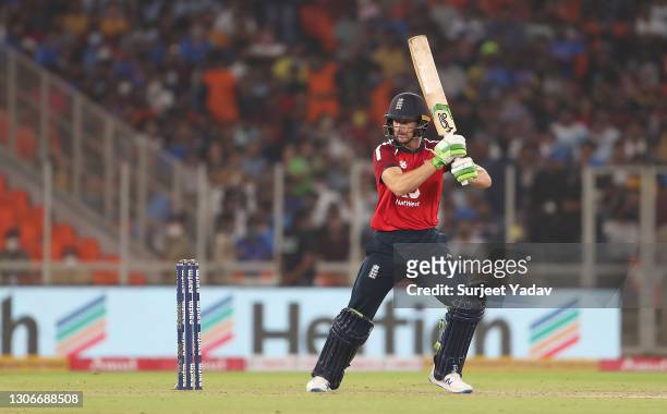 Jos Buttler of England drives the ball during the 1st T20 International match between India and England at Sardar Patel Stadium on March 12, 2021 in...