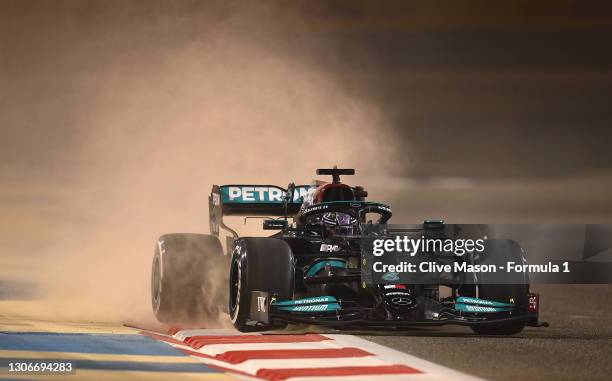 Lewis Hamilton of Great Britain driving the Mercedes AMG Petronas F1 Team Mercedes W12 kicks up sand as he runs wide during Day One of F1 Testing at...