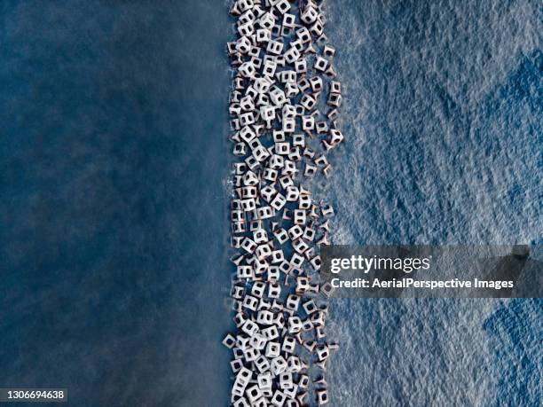 protection concrete barriers - beach bird's eye perspective stock pictures, royalty-free photos & images