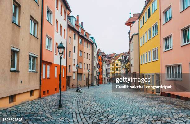 idyllic view of row houses on street, weissgerbergasse in nuremberg city, germany, europe - continental stock-fotos und bilder