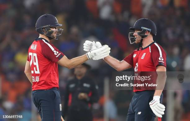 Dawid Malan and Jonny Bairstow interact as they celebrate following the 1st T20 International match between India and England at Sardar Patel Stadium...