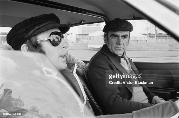Scottish racing driver Jackie Stewart giving advanced driving tuition to Scottish actor Sean Connery at Silverstone, Northamptonshire, 9th April 1973.