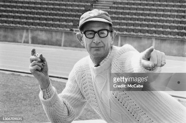 Ron Murray, a 56 year-old retired banker, working as trainer for British high jumper Barbara Inkpen, 29th March 1973.