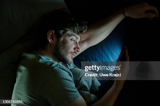 Man in bed on smartphone Man in bed on smartphone