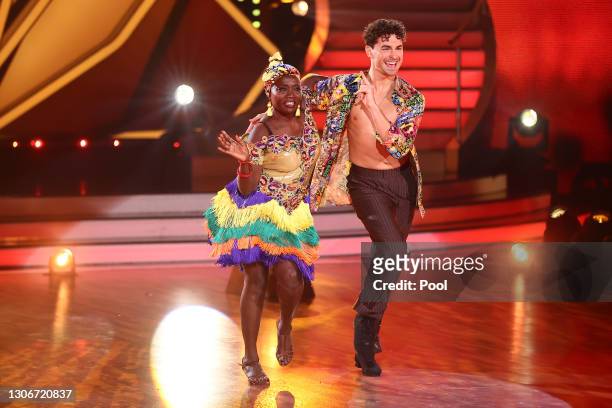 Auma Obama and Andrzej Cibis perform on stage during the 2nd show of the 14th season of the television competition "Let's Dance" on March 12, 2021 in...