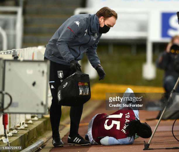 Bertrand Traore of Aston Villa receives medical attention after falling over the advertising boards during the Premier League match between Newcastle...