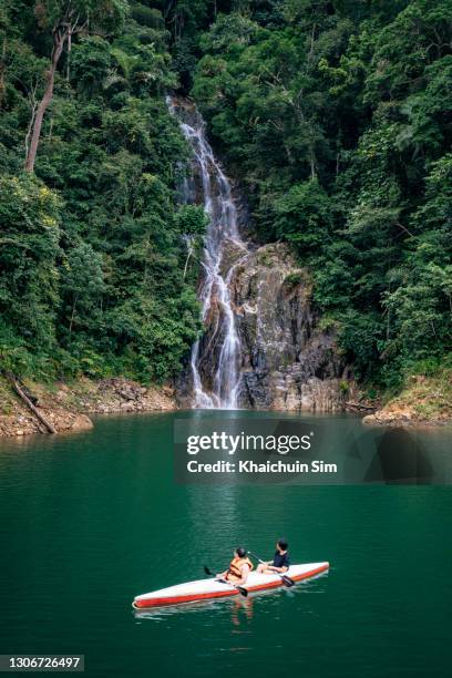 waterfall in tropical jungle and a canoe - terengganu stockfoto's en -beelden