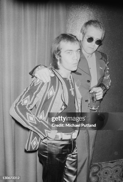 Elton John with his songwriting collaborator Bernie Taupin at a ceremony to award them gold discs for four of their co-written albums, 26th April...