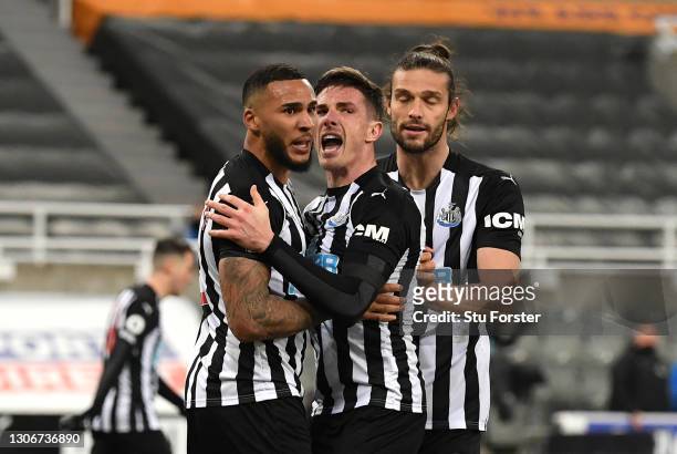 Jamaal Lascelles of Newcastle United celebrates with teammates Ciaran Clark and Andy Carroll of Newcastle United after scoring their team's first...