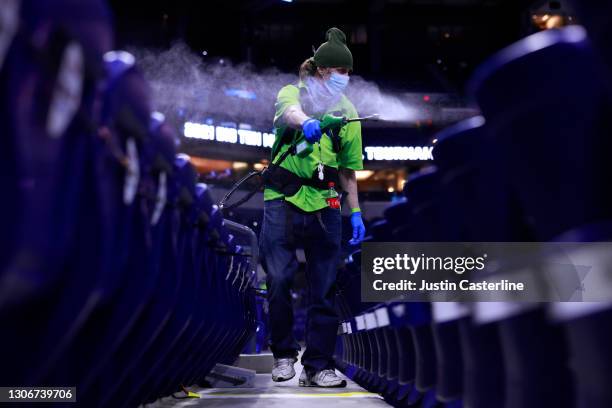 Lucas Oil Stadium employee disinfects the the seats due to Covid-19 after the game between the Purdue Boilermakers and Ohio State Buckeyes at Lucas...